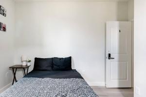 a bedroom with a bed and a white wall at Luxury Master Room 1 In Austin's Mckinney Falls in Austin