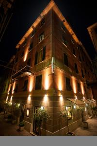 a tall building with lights on it at night at Hotel Astigiana & Appartamenti in Varazze