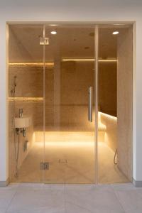 a glass shower in a bathroom with a sink at Villa Langberg Spa in Ventspils