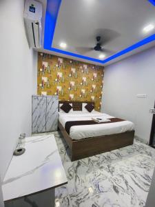 a room with a bed and a table in it at Seven star in Indore
