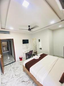a bedroom with a large bed and a tv at Seven star in Indore