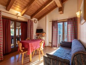 a living room with a table and a couch at Residenza 3-Tre in Madonna di Campiglio