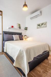 a bedroom with a large bed in a white room at BUDDA HOME in Tortuguero