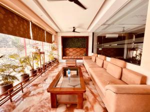 sala de estar con sofá y mesa en Hotel The Tirath View en Haridwār