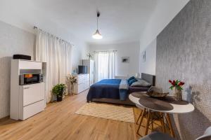 a bedroom with a bed and a table in a room at Ubytování v centru in Lanškroun