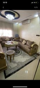 a living room with a couch and a table at Appartement Hay salam in Agadir