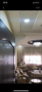 a living room with a couch and a window at Appartement Hay salam in Agadir