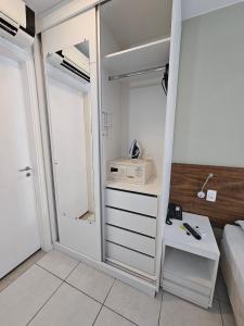 um quarto com uma cama e um armário branco em F1614 FG Apart Hotel Fusion WIFI Piscina Academia em Brasília