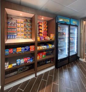 a grocery store with a refrigerator and lots of food at Clarion Pointe Lakeland I-4 in Lakeland