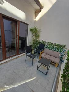a patio with a couch and two chairs at TRE SORELLE in Piran