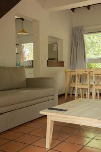 a living room with a couch and a table at Baden Baden Carilo in Carilo