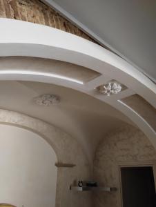 a ceiling in a room with a stone wall at Ellebi in Vibo Valentia +36 photos