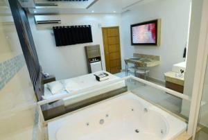 Habitación con baño con bañera grande. en Motel Fashion ABC 5, en Santo André
