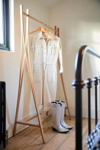 a dress on a rack with boots and a dress at Modja Modja House in Kent