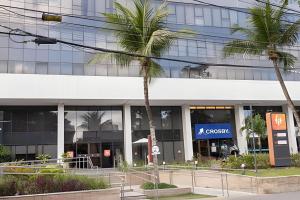 an office building with a company sign in front of it at Hosts BR-Flat Fit Transamérica Boa Viagem s/ taxa in Recife