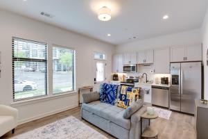 a living room with a couch and a kitchen at Nashville Condo, 3 Mi to Downtown Entertainment in Nashville