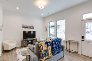 a living room with a couch and a tv at Nashville Condo, 3 Mi to Downtown Entertainment in Nashville