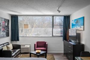 a room with a bed and a chair and a window at Studios On 25th by BCA Furnished Apartments in Atlanta