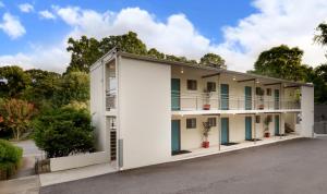 an exterior view of a white building with balconies at Studios On 25th by BCA Furnished Apartments in Atlanta