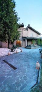 a house with a stone driveway in front of it at Villa Mazzini in Molinella