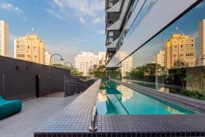 a building with a swimming pool in a city at BHomy Oscar Freire 2 in Sao Paulo