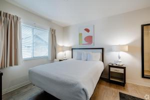 a bedroom with a large bed and a window at WaterWalk Extended Stay by Wyndham Wichita in Wichita