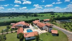 an aerial view of a house with a yard at Sítio com Piscina e Área de Lazer Completa in Porangaba