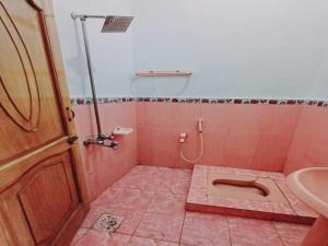 a pink bathroom with a toilet and a sink at Stay Inn Hotel in Mingāora