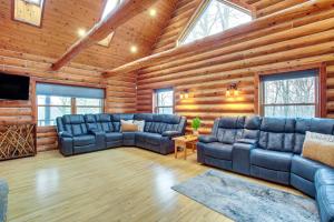 a living room with blue furniture in a log cabin at Family Home with Indoor Pool about 2 Mi to Elkhart Lake! in Elkhart Lake