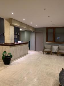 an empty lobby with a reception desk and chairs at akcayzeytin otel in Akcay