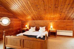 um quarto com uma cama num chalé de madeira em Les Chalets de Flaine Hameau - maeva Home - Chalet 5 Pièces 8 Personnes - Sé 135 em Flaine