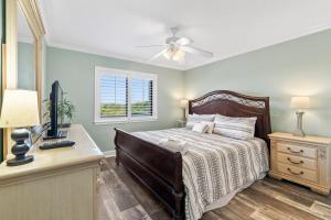 a bedroom with a bed and a desk and a window at Unit 3127 - Ocean & Racquet Club in Saint Augustine Beach +88 photos
