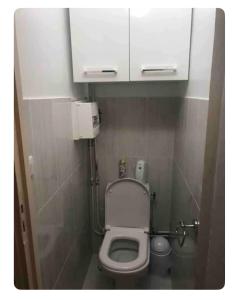 a small bathroom with a toilet with a white cabinet at Cros de Cagnes, apartment with the Best Location in Cagnes-sur-Mer