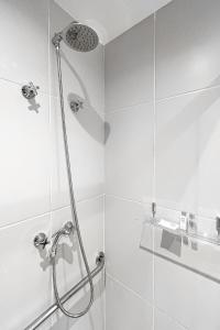 a shower with a shower head in a bathroom at BHomy Brooklin - Novo c varanda integrada BUR102 in Sao Paulo