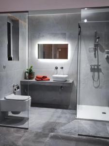 a bathroom with a sink and a toilet and a shower at B8 Luxury Suites - brand NEW - just 2 mins from the beach in St. Paul's Bay