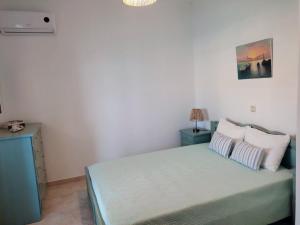 a bedroom with a bed with two pillows at Thalassa house by the sea in Áyios Yeóryios