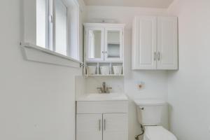 a white bathroom with a sink and a toilet at Family-Friendly Renton Retreat 15 Mi to Seattle! in Renton