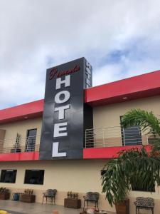 a hotel with a sign on the side of it at Hotel Pimenta in Pimenta Bueno