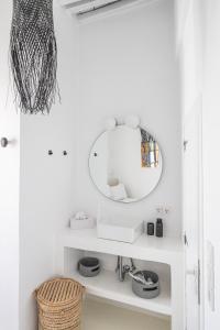 a bathroom with a mirror and a sink at Chiara Mykonos III in Mýkonos City