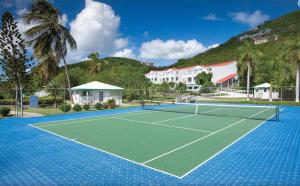 a tennis court in front of a resort at Caribbean Life in St. Thomas in Bolongo