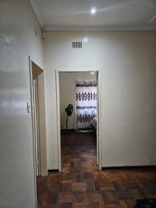 an empty room with a hallway with a door leading to a bedroom at Stay Sunrise in Nelspruit