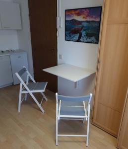 stół i krzesło w kuchni ze stołem i krzesłem w obiekcie Zimmervermietung Müller w mieście Zeltweg