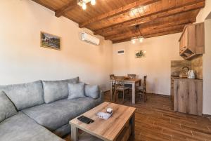 a living room with a couch and a table at Lake Valley in Virpazar