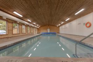 a large swimming pool with a wooden ceiling at Ocean Village Resort in Tofino