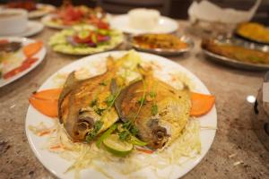 a plate of food on a table with food at Hotel New Sagar Priya in Digha
