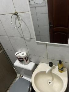 a bathroom with a toilet and a sink and a mirror at Apto próximo à Polícia Federal in Manaus