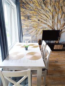 a dining room with a white table and chairs at Sweet Heart Home in Szczecin