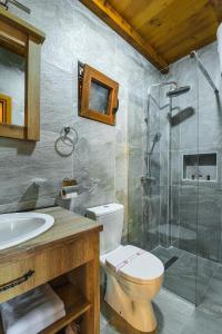a bathroom with a toilet and a glass shower at Lake Valley in Virpazar