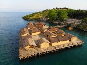 an island with a bunch of houses on the water at Villa Lakeview Paradise in Peštani