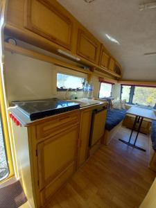 an rv kitchen with a sink and a stove at The Lakeside Cabin in Longmorn